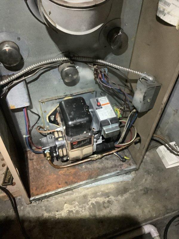 # After Hours Emergency Service Report

Responded to emergency no-heat call. Upon arrival, inspected furnace and found system inoperative. Accessed blower compartment and control section to diagnose issue. Examined electrical connections, gas valve assembly, and ignition control module. Located failed ignition control board preventing system operation. Tested gas valve functionality and verified proper voltage supply to components. Identified corroded base plate and accumulated debris within unit affecting performance. Cleaned accessible areas of blower wheel showing dust accumulation. Checked all wire connections including bundled field wiring with proper terminations. Replaced defective ignition control module and verified all electrical connections were secure. Cycled system through multiple heating cycles to confirm proper ignition sequence and burner operation. Verified blower motor engagement and airflow. System restored to full operational status. Advised customer of observed co