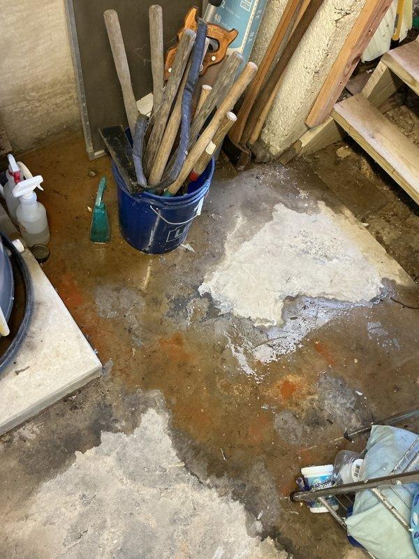 Responded to emergency call for water heater leak in basement utility area. Upon arrival, found active water seepage from water heater tank causing significant moisture damage to concrete floor with visible efflorescence and mineral deposits throughout the area. Assessed water heater condition, documented extensive floor staining and water accumulation, and identified compromised tank integrity as source of leak. Provided customer with repair options and recommendations for water heater replacement due to tank failure.