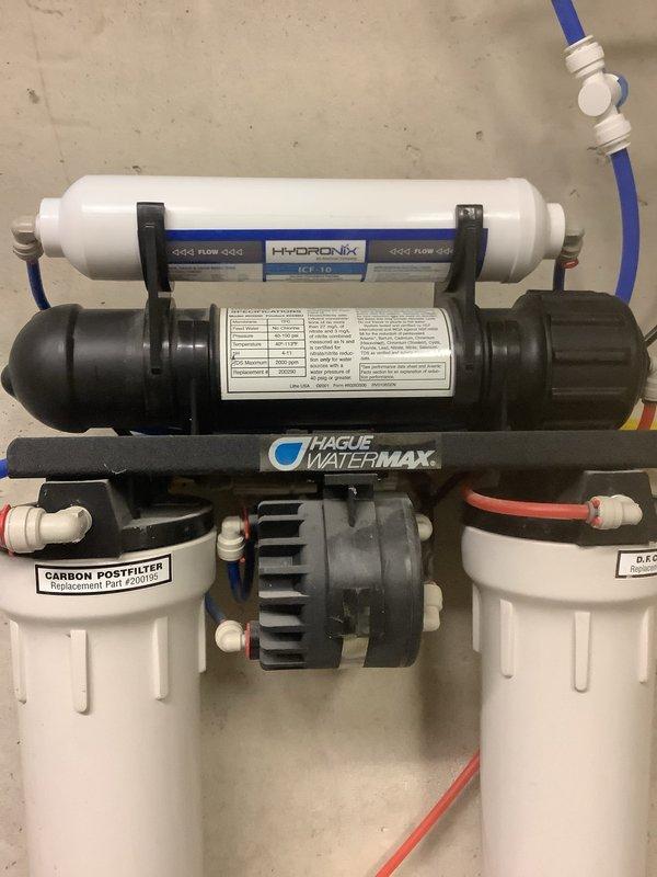 Responded to service call for leaking Hague Water Max 52 AMQ system that had been placed in bypass mode. Inspected the complete water treatment setup including the Water Max unit and Hague reverse osmosis system with Hydronix pre-filter, carbon post-filter, and RO membrane assembly. Evaluated system components, checked filter conditions, and assessed the leak source on the primary softener unit to determine necessary repairs using parts previously received and staged in warehouse.