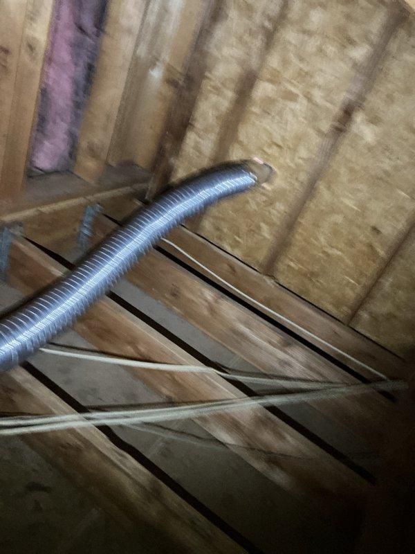 Rerouted dryer vent from improper termination in garage crawlspace to proper exterior exhaust. Installed rigid ductwork through attic space with appropriate support and sealed all connections to ensure code-compliant ventilation and prevent moisture buildup in enclosed areas.