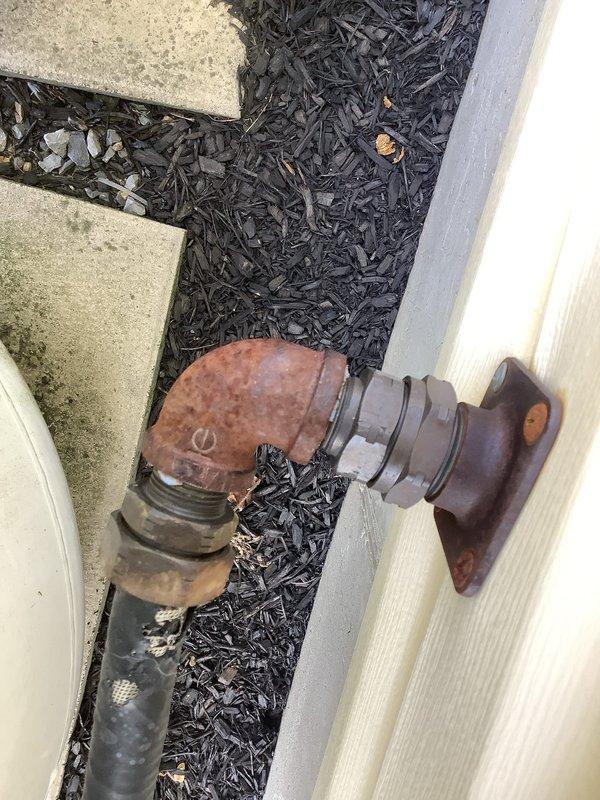 Responded to follow-up service call to repair gas leak on propane supply line from tank to house after propane delivery company identified and red-tagged the system. Repaired corroded gas piping connections and replaced deteriorated fittings on exterior propane line assembly, addressing leak points that had prevented system operation. Pressure tested repaired gas line to verify integrity, restored system to safe operating condition, and documented equipment condition with photographs showing exterior piping and HVAC components.