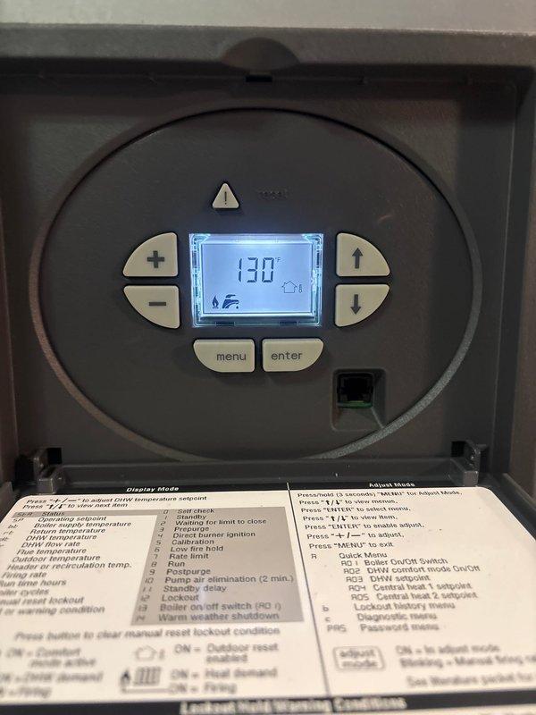 Replaced defective temperature and pressure gauge on Burnham Alta boiler under manufacturer warranty. Isolated boiler system and drained water to access gauge assembly. Removed failed gauge from copper piping and installed new replacement unit with proper fittings. Refilled boiler to correct operating pressure, purged air from system piping, and verified proper operation of new gauge with accurate temperature and pressure readings displayed.