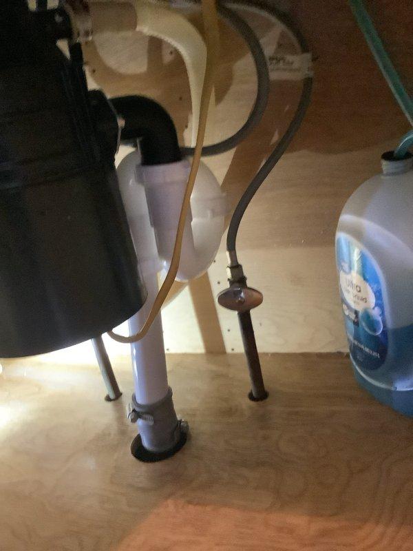 Responded to emergency call for active leak under kitchen sink. Upon arrival, found water leaking from disposal or drain connections, with customer using bucket for temporary containment. Inspected garbage disposal unit and associated drain plumbing, identified source of leak, and performed necessary repairs to stop water flow and restore proper drainage function.