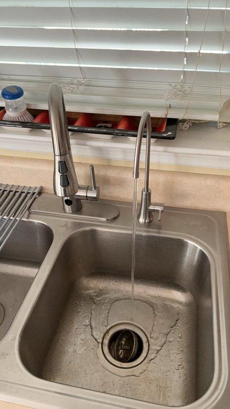 Installed new Elkay beverage faucet at kitchen sink location. Mounted faucet assembly adjacent to existing primary kitchen faucet on undermount stainless steel sink basin. Connected water supply line to ensure proper flow and pressure for beverage dispensing applications. Tested installation for leaks and verified operational functionality of all components. Installation complete with dual faucet configuration now operational at sink workstation.