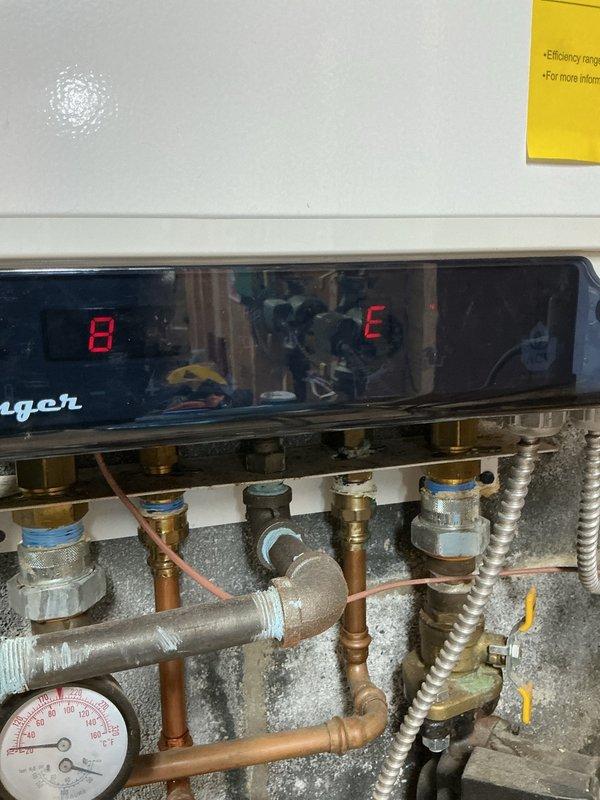 Responded to no hot water complaint on Triangle Tube Challenger CC125 propane-fired water heater installed in 2016. Upon arrival, found unit displaying error code 8E on control panel, indicating a flame sensing or ignition system fault. Inspected blower motor assembly, verified proper operation and electrical connections. Examined gas valve, pressure regulator, and supply lines for proper function. Checked flame sensor for carbon buildup and contamination. Verified all safety interlocks, pressure switches, and limit controls. Cleared error code, cycled unit through complete heating sequence, and confirmed restoration of hot water production with proper flame signal and combustion operation.