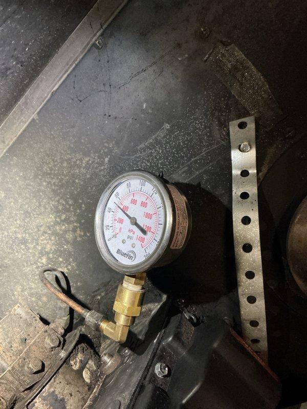 Responded to no heat call on existing oil heating system for new customer with unit approximately 12-14 years old. Initial service visit required rescheduling to accommodate customer availability. Upon arrival, verified oil tank levels and assessed system operation. Installed and tested pressure gauge on heating system, confirming proper operating pressures. System restored to normal operation with heat functioning properly.