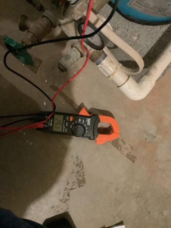 Responded to intermittent water loss affecting all fixtures throughout the residence. Inspected well pump, pressure switch, and water treatment system including Hague water softener and acid neutralizer installed in 2024. Upon examination, discovered acid neutralizer media level unchanged and water softener salt level static for three months, indicating treatment system not cycling properly. Performed raw and treated water quality testing using test strips to analyze iron levels and pH values at kitchen sink location. Utilized multimeter to test electrical components and pressure switch functionality. Conducted comprehensive plumbing system inspection as requested. Water filter housing showed white mineral buildup on exterior, suggesting water chemistry issues. Documented findings with water test results and system condition for customer records.