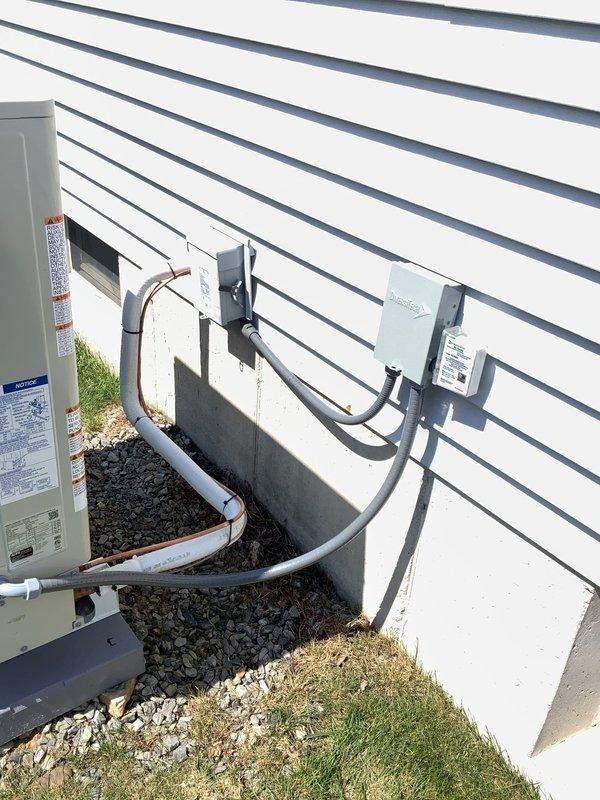 Completed re-check of recently installed Moyer Series heat pump and Daikin ductless heat pump system. Performed AC operational check on both units, re-wired electrical disconnect, verified humidifier wiring connections, and installed REME Halo LED air purification system. Delivered utility rebate packet for completion and documented installation with photos showing exterior equipment mounting and interior air handler configuration.