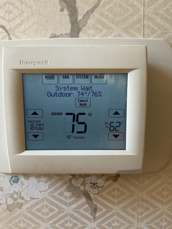 Responded to service call for downstairs HVAC unit that would not turn on. Upon arrival, found thermostat displaying "System: Wait" status, indicating a safety delay timer was active. Inspected 9-year-old heat pump system including outdoor condenser unit and indoor components. Replaced air filters on both upstairs and downstairs HVAC units as requested. Verified outdoor condenser unit fan assembly and protective guard were intact and functioning properly. System resumed normal operation after safety timer cycle completed.