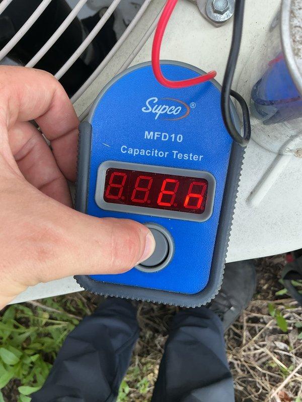 Responded to no-cooling complaint on air conditioning system. Upon arrival, confirmed condenser fan motor not operating and unit producing humming sound when system called for cooling. Performed diagnostic testing and identified failed run capacitor. Tested capacitor using digital MFD tester, confirming component out of specification. Replaced defective capacitor with proper replacement unit, restored system to normal operation, and verified condenser fan motor running properly with adequate airflow through outdoor coil.