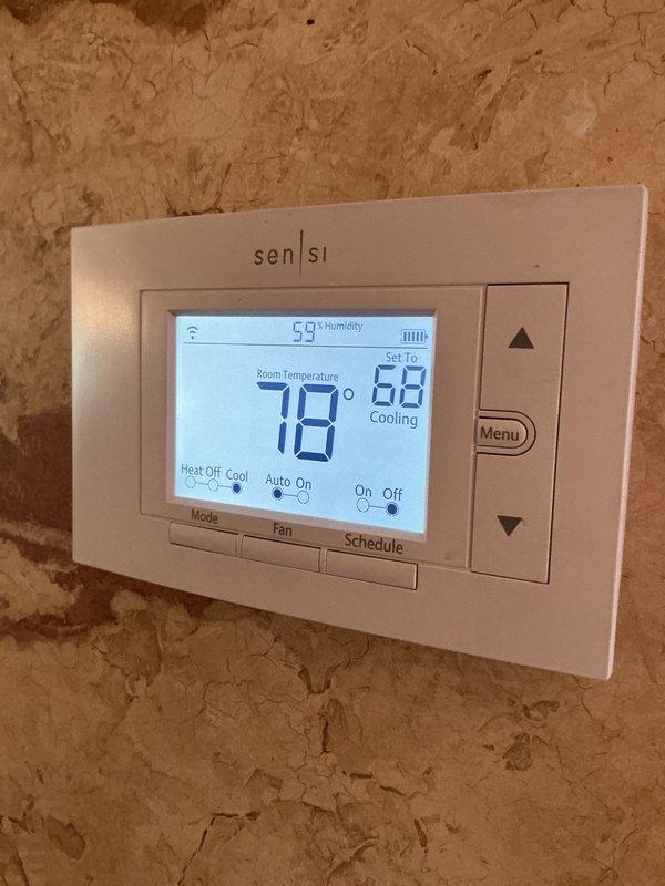Responded to emergency service call for thermostat unable to switch to cooling mode. Upon arrival, diagnosed issue with Sensi digital thermostat that was preventing mode changeover from heating to cooling operation. Successfully repaired thermostat functionality, restoring proper cooling mode operation. Verified Trane condensing unit responding correctly to thermostat commands and system now operating as designed with proper temperature control.