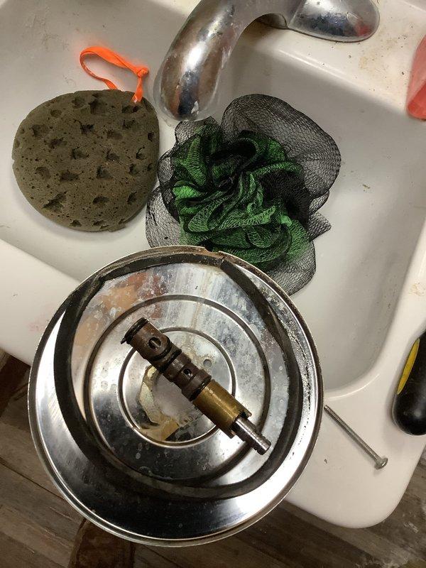 Responded to emergency no-water situation where family room shower could not be shut off after use. Upon inspection, discovered faulty shower valve assembly lacking dedicated shutoff valve. Removed defective shower diverter mechanism and cartridge assembly from wall-mounted fixture. Replaced malfunctioning valve components with new cartridge and escutcheon plate. Restored water control functionality to shower, allowing household water system to be safely reactivated. Verified proper operation of handheld shower attachment and tested for leaks at all connection points.