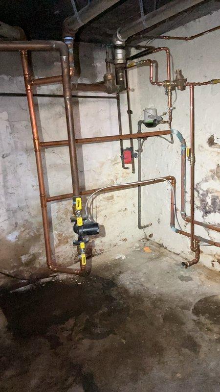Responded to no domestic hot water complaint on combination boiler system. Upon arrival, found unit in standby mode displaying 71°F and 0 kbtu/hr on digital control panel with max efficiency setting enabled. Inspected boiler piping configuration including copper supply and return lines, yellow-handled isolation valves, and associated pressure regulation components. Diagnosed issue preventing domestic hot water production while heating system remained operational. Evaluated control board status indicators and verified system parameters on LCD display. Examined plumbing connections at boiler manifold including brass fittings and ball valves serving both heating and domestic hot water circuits. Performed necessary repairs to restore domestic hot water functionality. Cycled system through complete operational test to confirm proper heating and hot water production. Verified all safety controls operating within normal parameters. Unit left in full working condition with both heating and dom