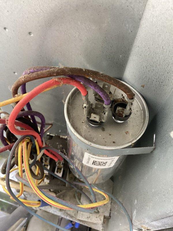Responded to no cooling complaint with indoor fan and outdoor unit running but no cold air production. Performed diagnostic testing and measured supply air temperature at 88.8°F, confirming lack of cooling. Identified failed capacitor with discolored and deteriorated wiring connections. Replaced defective capacitor, verified proper electrical connections, and restored system to normal cooling operation.