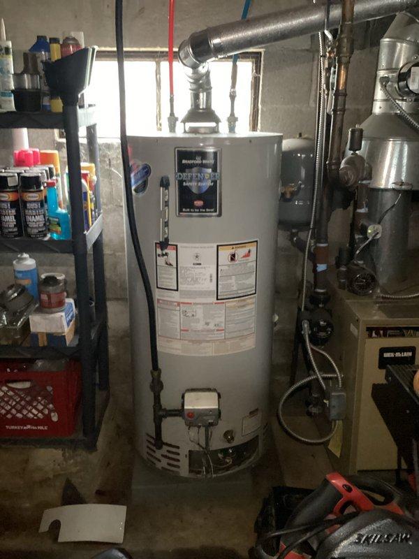 Responded to after hours emergency call for water heater complications. Upon arrival, performed comprehensive diagnostic assessment of residential gas-fired water heater system located in basement mechanical room. Utilized combustion analyzer to measure flue gas temperatures and CO2 levels, recording exhaust temperature of 523.6°F and CO2 reading of 7.3%. Tank surface temperature measured at 85.2°F. Inspection revealed water heater operating within normal parameters with proper venting through metallic ductwork. All safety labels and manufacturer specifications verified intact. System tested and confirmed operational with no immediate safety concerns identified.