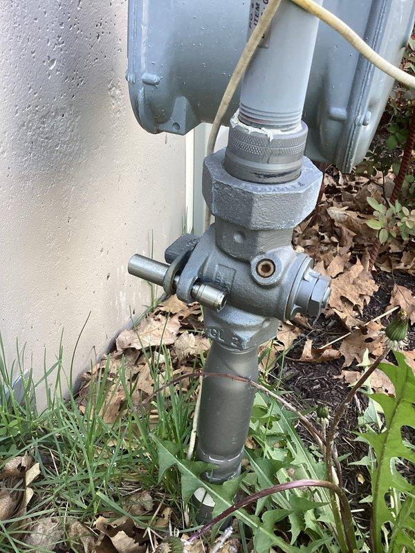 Responded to service call for natural gas Amana heating system with intermittent operation issues. Customer reported unit was cycling on and off sporadically, and after previous thermostat replacement provided temporary resolution, system now fails to initiate heating cycle entirely. Upon arrival, performed diagnostic assessment of heating system including inspection of gas valve assembly, control board wiring connections, and external gas supply line. Verified natural gas supply at exterior meter connection point and confirmed proper gas flow to unit. Examined gas valve control module and associated electrical connections, noting multiple wire terminations to valve assembly. Inspected thermostat communication circuit and verified proper voltage at control board. Documented equipment condition through photographic evidence of gas valve assembly and exterior gas meter connection. System evaluation revealed potential issues with gas valve operation or control board signal communication p