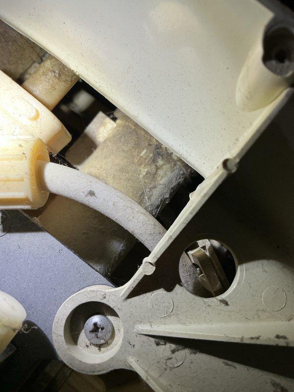 Responded to water leak complaint with green overflow hose discharging water near water softener causing carpet saturation. Inspected softener system which was already in bypass mode and traced water source. Evaluated well water pump experiencing intermittent sputtering operation, potentially indicating air intrusion in supply lines. Documented system conditions with photographs showing plumbing components, insulated piping, mounting brackets, and mechanical connections. Discussed possible low water table concerns and provided estimates for pump replacement and potential extension of drop piping to address intermittent performance issues.