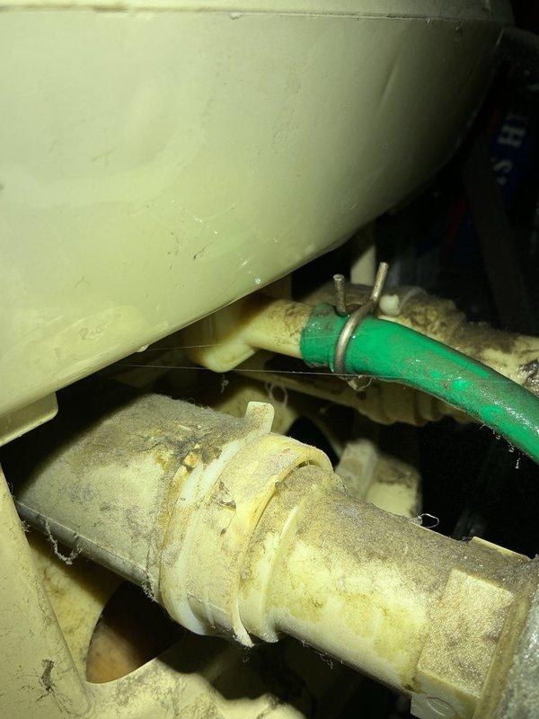 Responded to water leak complaint with green overflow hose discharging water near water softener causing carpet saturation. Inspected softener system which was already in bypass mode and traced water source. Evaluated well water pump experiencing intermittent sputtering operation, potentially indicating air intrusion in supply lines. Documented system conditions with photographs showing plumbing components, insulated piping, mounting brackets, and mechanical connections. Discussed possible low water table concerns and provided estimates for pump replacement and potential extension of drop piping to address intermittent performance issues.