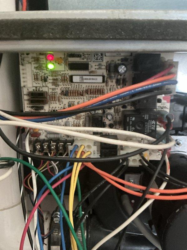 Responded to service call for propane furnace experiencing continuous humming noise. Upon inspection, accessed control panel and examined circuit board, wiring connections, and electrical components. Verified proper LED indicator function on control board and inspected all wire terminations including power, control, and safety circuit connections. Checked flexible conduit connections and assessed capacitor and relay components for proper operation. System evaluated and findings documented with photos of control board assembly and component wiring for reference.