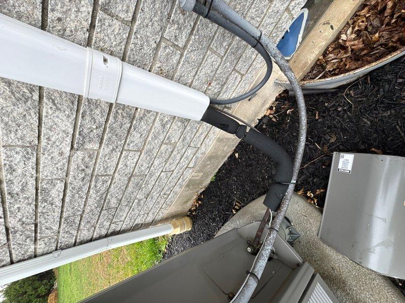 Completed comprehensive air conditioning maintenance check on heat pump system installed in April 2021. Performed thorough inspection of outdoor condensing unit, including examination of condensate drain lines, electrical connections, and refrigerant lines with foam insulation. Inspected indoor air handler unit located in attic space, verified proper operation of all components, and documented system condition with photographs for service records.
