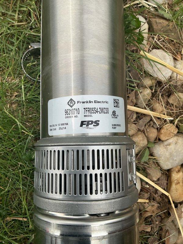 Replaced failed well pump with new Franklin Electric 7FR05S4-2W230 submersible pump unit. Extended well pipe and electrical wiring approximately 30 feet to accommodate proper pump depth based on specifications from previous pressure tank documentation. Removed obsolete water softener system from premises to facilitate installation access and system modernization.