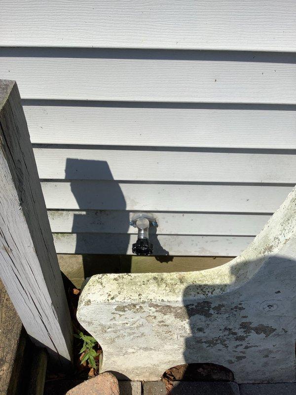 Responded to call regarding leaking outdoor hydrant at front of property. Upon arrival, confirmed hydrant had been shut off by customer to prevent further water loss. Inspected exterior hose bib and surrounding mounting area, noting weathered concrete block installation and aged hardware components. Assessed condition of hydrant assembly, mounting brackets, and connection points for source of leak. Documented existing conditions showing significant weathering and deterioration of mounting structure and hardware. Secured hydrant assembly and verified water supply remained in off position to prevent additional leakage until permanent repairs could be scheduled.