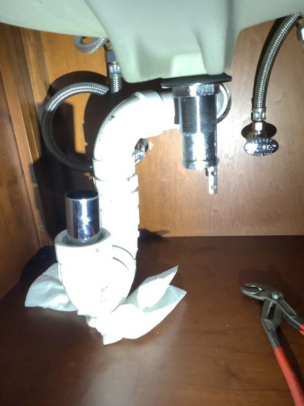 Responded to return visit to replace pop-up assembly and shower cartridge. Upon arrival, found customer had disassembled lavatory sink trap for cleaning over the weekend and was unable to properly reconnect drain piping. Reassembled and secured all drain connections under lavatory sink, ensuring proper alignment and seal of trap assembly. Completed installation of new pop-up drain assembly and replaced shower cartridge as originally scheduled.