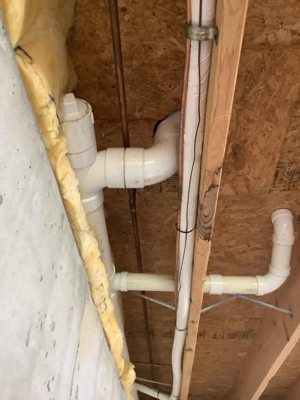 Responded to service call for toilet leaking into basement below. Upon inspection, identified failed wax ring seal at toilet base allowing water to seep through floor into lower level. Examined toilet flange condition, verified structural integrity of surrounding flooring, and tested water pressure throughout system. Presented homeowner with multiple repair and upgrade options including toilet replacement with standard or pressure-assisted flush models, flange repair or replacement, new shut-off valve and supply lines, wax ring and mounting bolt replacement. Documented existing conditions with photographs of toilet fixture and basement plumbing infrastructure showing PVC drain lines and evidence of water infiltration.