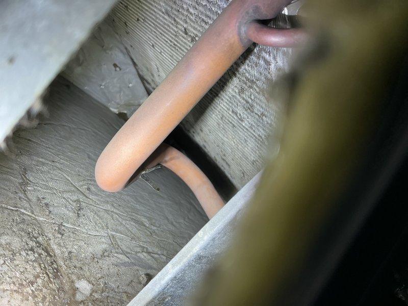 Performed diagnostic evaluation on 20+ year old heat pump system with history of evaporator coil frosting during high humidity conditions. Inspected refrigerant lines and insulation in crawlspace area, verified line set routing and support, and tested system operation using electronic testing equipment to assess electrical components and refrigerant circuit performance.