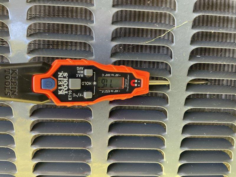 Responded to no cooling complaint at mobile home where AC unit was running continuously but failing to maintain temperature, with indoor temps reaching 81°F despite thermostat set at 70°F. Performed diagnostic inspection of outdoor condenser unit and electrical connections, taking temperature and system readings with digital multimeter. Found condenser coil with visible contamination and discoloration requiring cleaning, and verified electrical connections at terminal block were secure with proper voltage present across all phases.