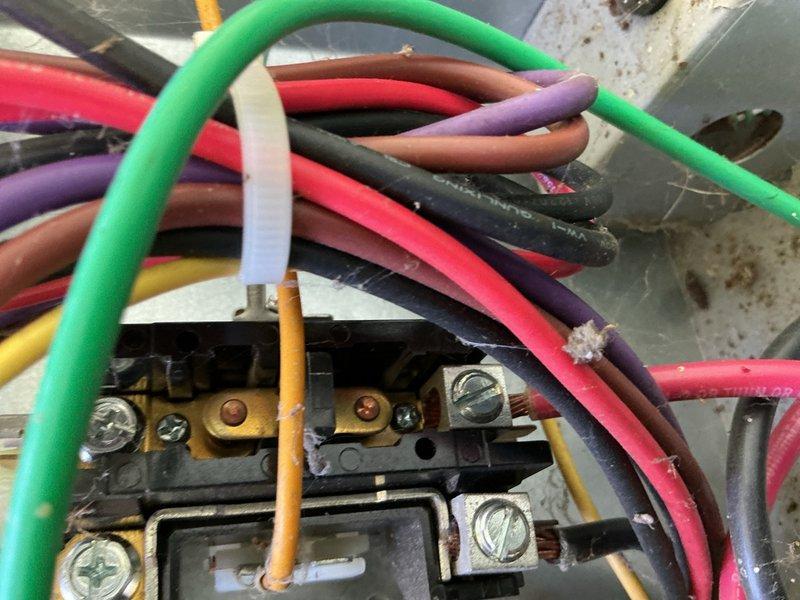 Responded to no cooling complaint at mobile home where AC unit was running continuously but failing to maintain temperature, with indoor temps reaching 81°F despite thermostat set at 70°F. Performed diagnostic inspection of outdoor condenser unit and electrical connections, taking temperature and system readings with digital multimeter. Found condenser coil with visible contamination and discoloration requiring cleaning, and verified electrical connections at terminal block were secure with proper voltage present across all phases.