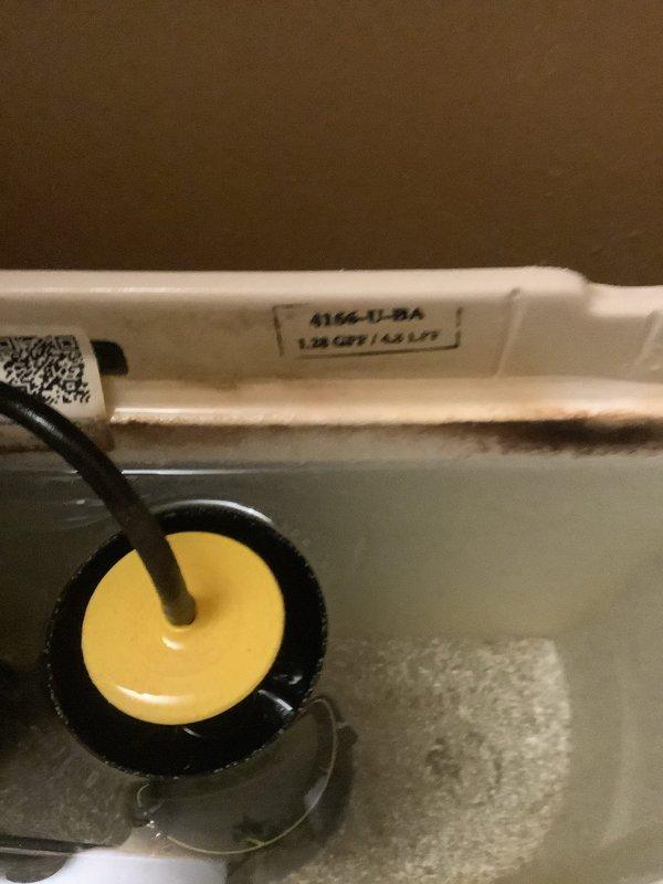 Responded to after hours emergency for leaking toilet. Replaced defective tank-to-bowl gasket with part retrieved from warehouse shelf and installed new mounting bracket using gasket from truck stock. Leak eliminated and fixture restored to proper operation.