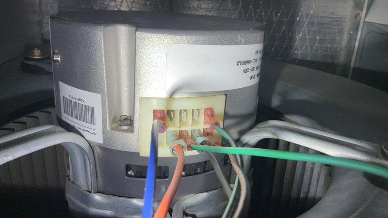 Responded to customer report of strange odor and short cycling from outdoor unit. Upon arrival, performed comprehensive preventive maintenance inspection on Rheem heat pump system installed in 2017. Inspected blower motor assembly, verified electrical connections and wiring integrity on motor terminal block. Examined internal components including capacitors, inductor coil, and circuit board elements for signs of failure or damage. Replaced thermostat battery as requested. System had been shut down by customer to prevent compressor damage. Completed full cooling season tune-up including visual inspection of all accessible components, electrical connections, and mechanical assemblies. Documented equipment condition with photos showing blower motor, wiring harnesses, and internal electrical components.
