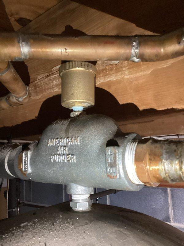 Responded to service call for leaking and hissing air relief valve on boiler system. Upon inspection, found Michigan automatic air vent installed in system experiencing intermittent leakage, likely due to recent plumbing modifications that added new piping to the boiler. Evaluated air elimination components and circulator pump connections for proper operation. System configured for summer/winter domestic hot water hookup operation.