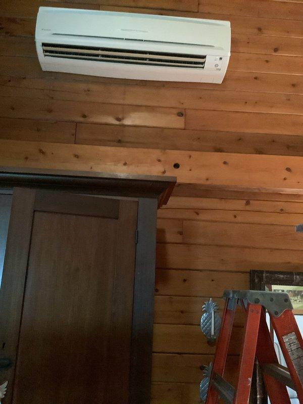 Responded to service call for Daikin ductless mini-split system with four indoor heads. Inspected largest head unit located in dining room with reported louver malfunction. Confirmed horizontal venting option inoperative while vertical positioning remains functional, indicating internal louver gear mechanism failure. Upon opening unit for inspection, discovered significant dust and lint accumulation on internal components and blower assembly, which can contribute to mechanical binding and premature wear of moving parts. System otherwise operating normally with adequate cooling performance. Discussed repair options with customer, including louver motor/gear assembly replacement. Noted unit age at 15-20 years and discussed system obsolescence concerns. Customer aware that replacement parts availability may be limited due to age of equipment. System continues to provide cooling function with vertical airflow direction. Recommended monitoring system performance and provided options for rep