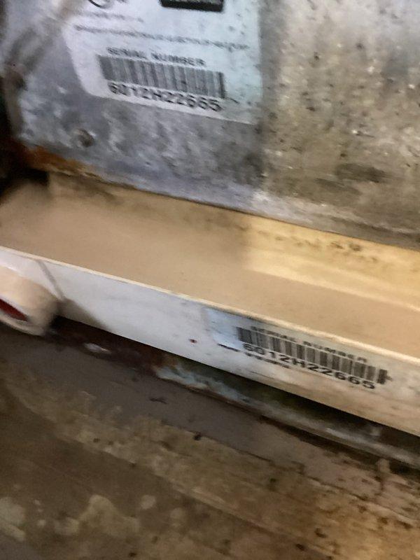 Responded to service call for reported leak near condensate pump and air handler assembly. Upon inspection, located active water leak at P-trap connection in condensate drain line beneath air handler unit. Identified compromised pipe joint and deteriorated rubber boot seal at floor penetration point allowing condensate water to escape. Evaluated drain line configuration and structural framing around affected area to determine proper repair approach. Documented existing conditions with photographs showing P-trap assembly, PVC drain piping, floor joists, and compromised sealing components for service records and future reference.