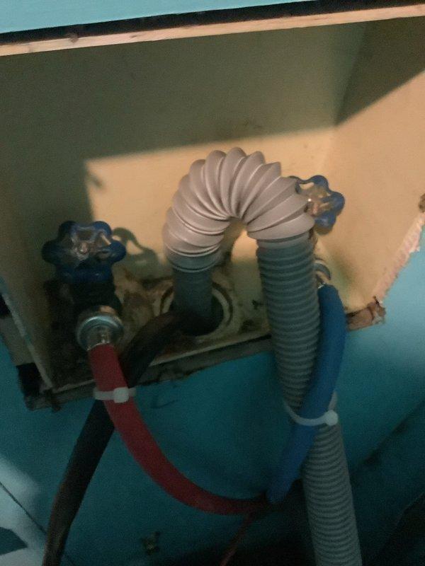 Responded to emergency callback for kitchen sink clog that escalated to active water leak beneath cabinet and onto floor. Addressed warranty issue with washing machine drain connection installed previously, which developed a small leak. Inspected plumbing assembly including valve system with dual shut-off controls, flexible corrugated supply lines, and drainage connections in utility area. Repaired leaking drain line, secured all connections, and verified proper water flow to resolve both the cabinet leak and washer drain issue.