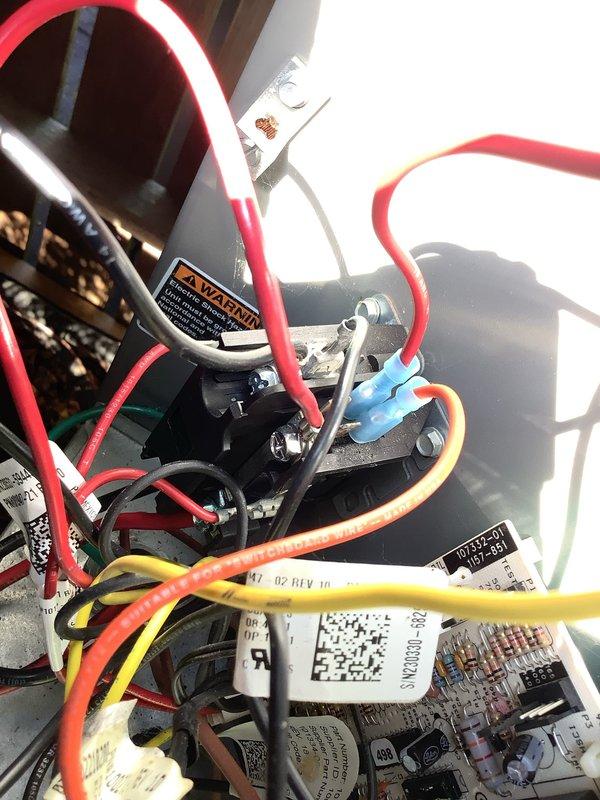 Responded to no cooling complaint on residential AC system. Customer reported unit went down overnight with no cool air output despite system running after restart. Upon arrival, inspected electrical components including control board, capacitor, and relay assembly. Examined wire connections at multiple terminals showing red, yellow, white, purple, and orange conductors. Verified proper connections at capacitor terminals and contactor assembly. Reviewed system service history noting previous issues with this unit. Performed diagnostic evaluation of control circuitry and electrical components to identify cause of cooling failure. Documented component conditions with photos of control board assembly and capacitor/relay configuration for service records.