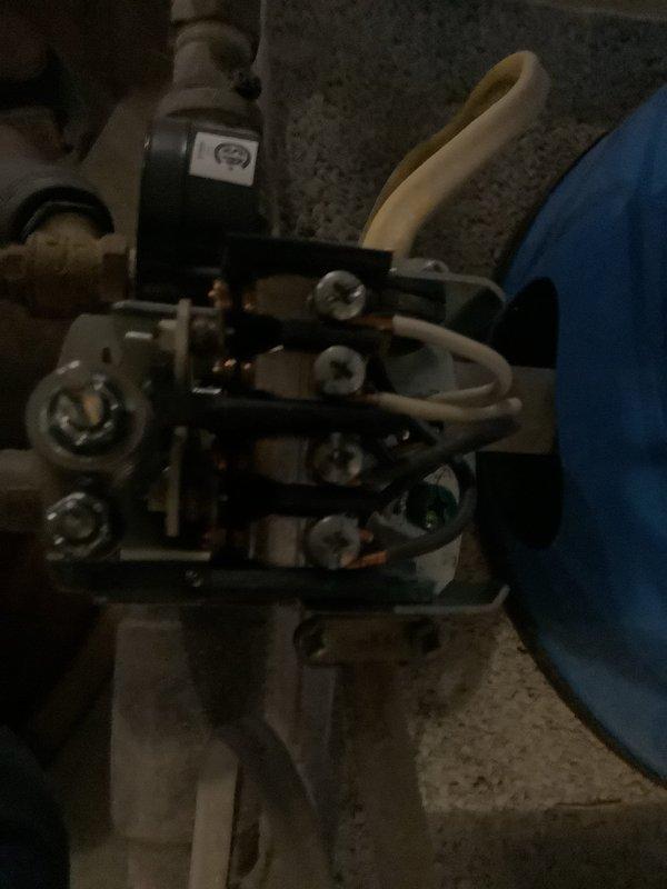 Responded to complaint of inconsistent water pressure with intermittent loss of water flow. Diagnosed failed pressure switch on well water pressure tank system. Removed and replaced defective pressure control switch and associated electrical connections. Disassembled corroded tank components showing signs of sediment buildup and internal corrosion. Reinstalled system with new hardware and clamps, verified proper electrical connections, and tested pressure cycling to confirm consistent water pressure restoration throughout property.