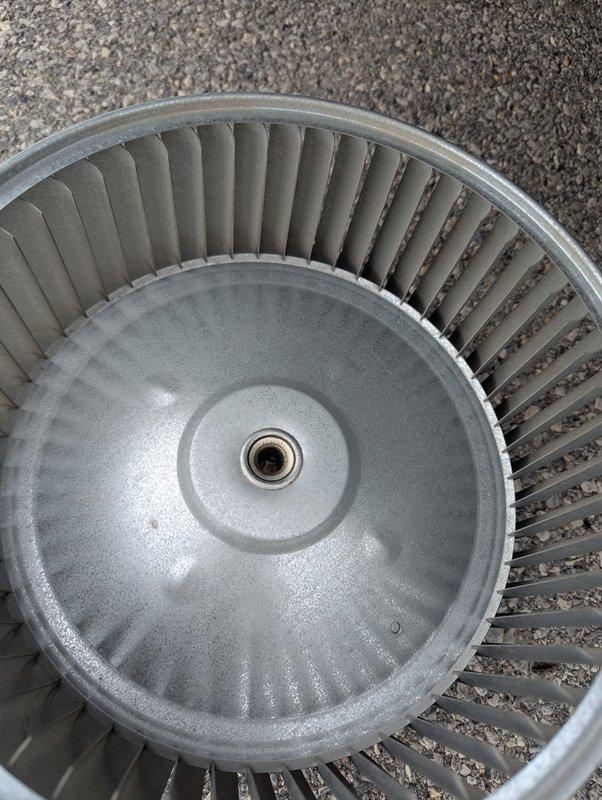 Performed comprehensive coil cleaning and blower wheel cleaning on air conditioning system. Removed and thoroughly cleaned the squirrel cage blower wheel, eliminating accumulated dust and debris from the curved blades and metal surfaces to restore proper airflow efficiency. Cleaned evaporator coil fins to improve heat exchange performance and system cooling capacity.