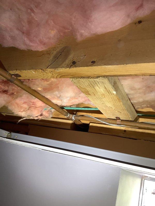 Responded to report of leaking exterior hose bibb that leaked during use but eventually stopped when turned off. Inspected frost-free style hose bibb mounted on building exterior and accessed attic space to examine the supply line and valve assembly. Identified worn stem assembly as source of leak. Replaced stem and internal kit components to restore proper seal and eliminate leakage during operation. Tested unit under pressure to verify repair and confirm no further leaks present.
