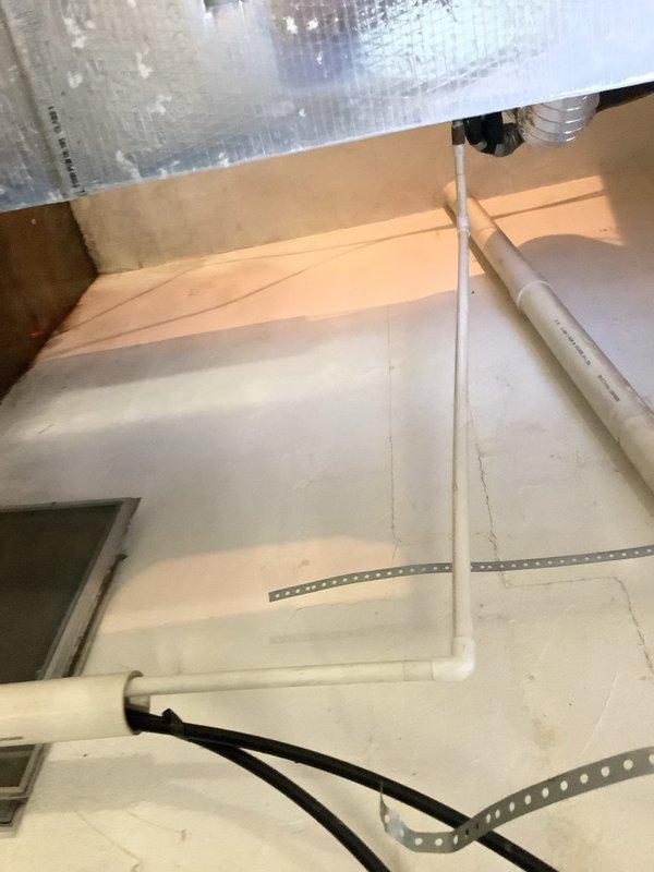 Responded to service call for water leaking in basement from recently installed Trane AC system. Upon inspection, found condensate drain line was blocked internally despite external drain pipe being clear. Located blockage in condensate line routing through basement ceiling joists. Cleared obstruction from condensate drainage system and verified proper flow. Inspected evaporator coil and drain pan for additional issues - found significant moisture accumulation on ductwork and surrounding insulation due to drainage backup. Tested system operation after clearing blockage and confirmed condensate now draining properly with no further leaking. Recommended air filter replacement and advised homeowner to monitor drainage over next few cooling cycles to ensure complete resolution.