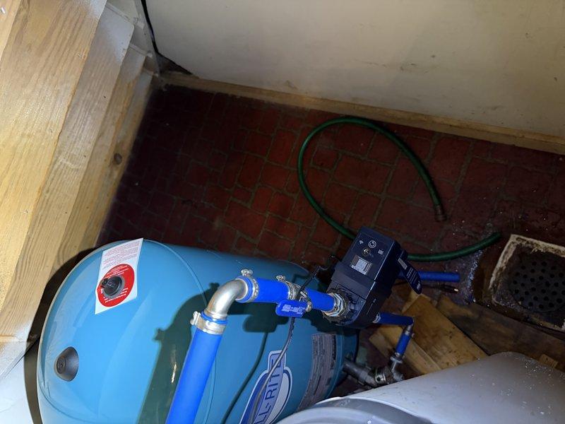 Responded to water system shutdown issue affecting household water supply. Replaced failed well pressure tank with new WR-80 model in utility room beneath stairs. Installed stainless steel tank tee to improve system configuration and water flow management. Added unions on water heater connections to facilitate future maintenance and service access. Shut down water supply to complete installation safely. Reconnected all plumbing lines, tested system operation, and verified proper pressure cycling and water delivery throughout the residence.