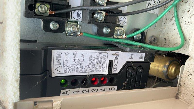 Responded to no cooling complaint on Daikin ductless mini-split system installed in 2018. Three indoor air handler units on second and third floors were operating in fan mode only with no heating or cooling capability. Performed diagnostic testing and temperature measurements on affected units. Inspected electrical connections and control board terminals on outdoor condensing unit. Issue began one day prior to service call. System requires follow-up visit to complete repairs and restore full heating and cooling functionality to all zones.