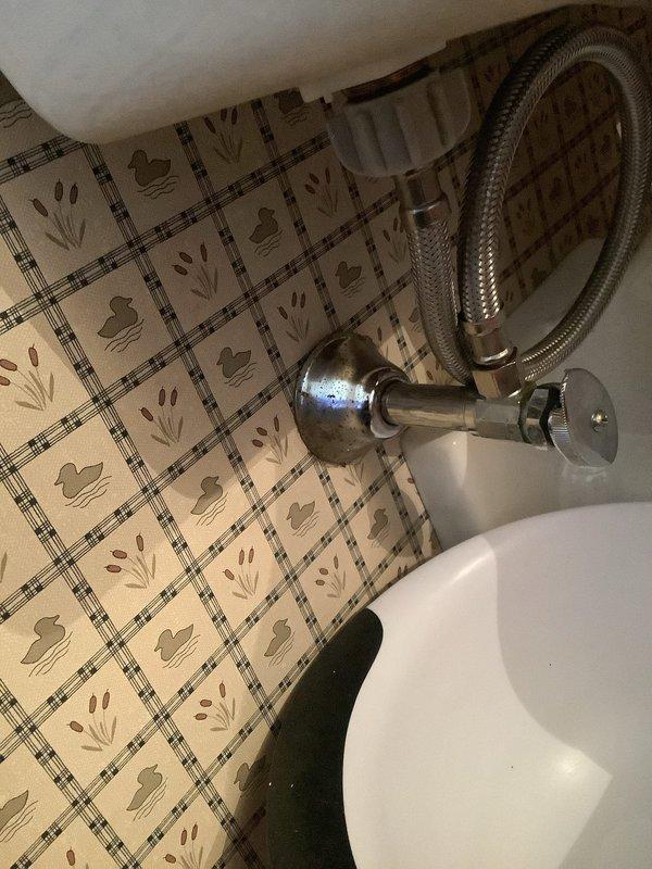 Responded to after-hours emergency for reported toilet leak. Upon arrival, inspected bathroom plumbing fixtures and identified water seepage from toilet supply line connection at the angle stop valve. Tightened compression fitting on braided supply line and verified all connections at the chrome shut-off valve were secure. Tested system by cycling water supply and flushing toilet multiple times to confirm leak was resolved with no further water discharge observed.