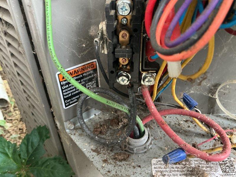 Responded to service call for Lennox air conditioning system not maintaining temperature with indoor unit freezing up in basement. Upon inspection, found evidence of previous refrigerant addition and signs of system age with visible corrosion on components. Diagnosed freezing coil condition, documented electrical connections at outdoor unit and indoor air handler condition with rust present on mounting brackets and housing. System installed approximately 11 years ago with recent filter change completed by occupant prior to service visit.