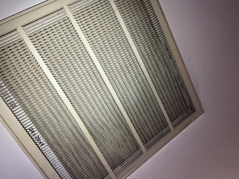 Completed comprehensive preventive maintenance inspection on existing air conditioning system, approximately 5 years old, for first-time customer. Performed standard AC tune-up procedures including system evaluation, filter inspection, and operational testing. Inspected air return vent showing dust accumulation on louvers and grille, indicating normal usage patterns. Accessed attic space to examine HVAC ductwork routing, confirming proper flexible duct installation with insulation wrapping and adequate support. Verified airflow pathways and duct integrity throughout accessible areas. System operating within normal parameters upon completion of inspection.