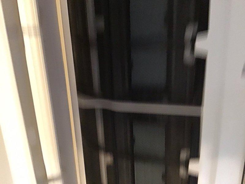 Completed preventive maintenance inspection on Daikin mini-split heat pump system installed in 2018. Accessed indoor air handler unit, inspected internal components including evaporator coil assembly, blower housing, and filter compartments. Noted moderate dust and debris accumulation on metal framework, perforated mounting brackets, and ductwork surfaces indicating need for cleaning during service. Documented equipment condition through photographic inspection showing operational components and overall system status for maintenance records.
