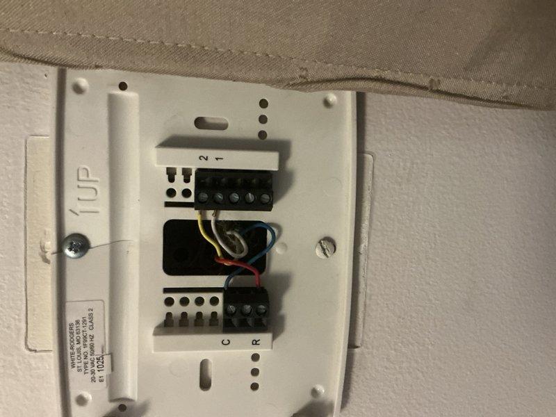 Responded to no cooling call on Amana system reported to be in lockout mode. Upon arrival, inspected thermostat and verified wiring connections at terminal blocks, documenting proper wire placement including R, C, Y, and W terminals. Performed diagnostic evaluation of system lockout condition and thermostat communication issues to determine root cause of cooling failure.