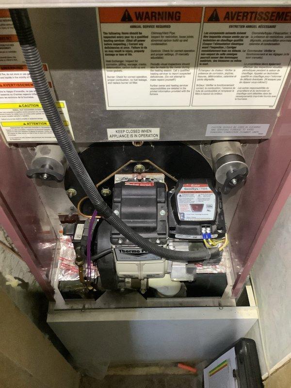 Responded to service call regarding excessive moisture accumulation requiring daily removal of approximately one bucket of water from HVAC system. Upon inspection, identified clogged condensate drain P-trap as the likely cause of water leakage around seal area. Documented Tempstar outdoor condenser unit and Thermo brand blower assembly with photos for service records.